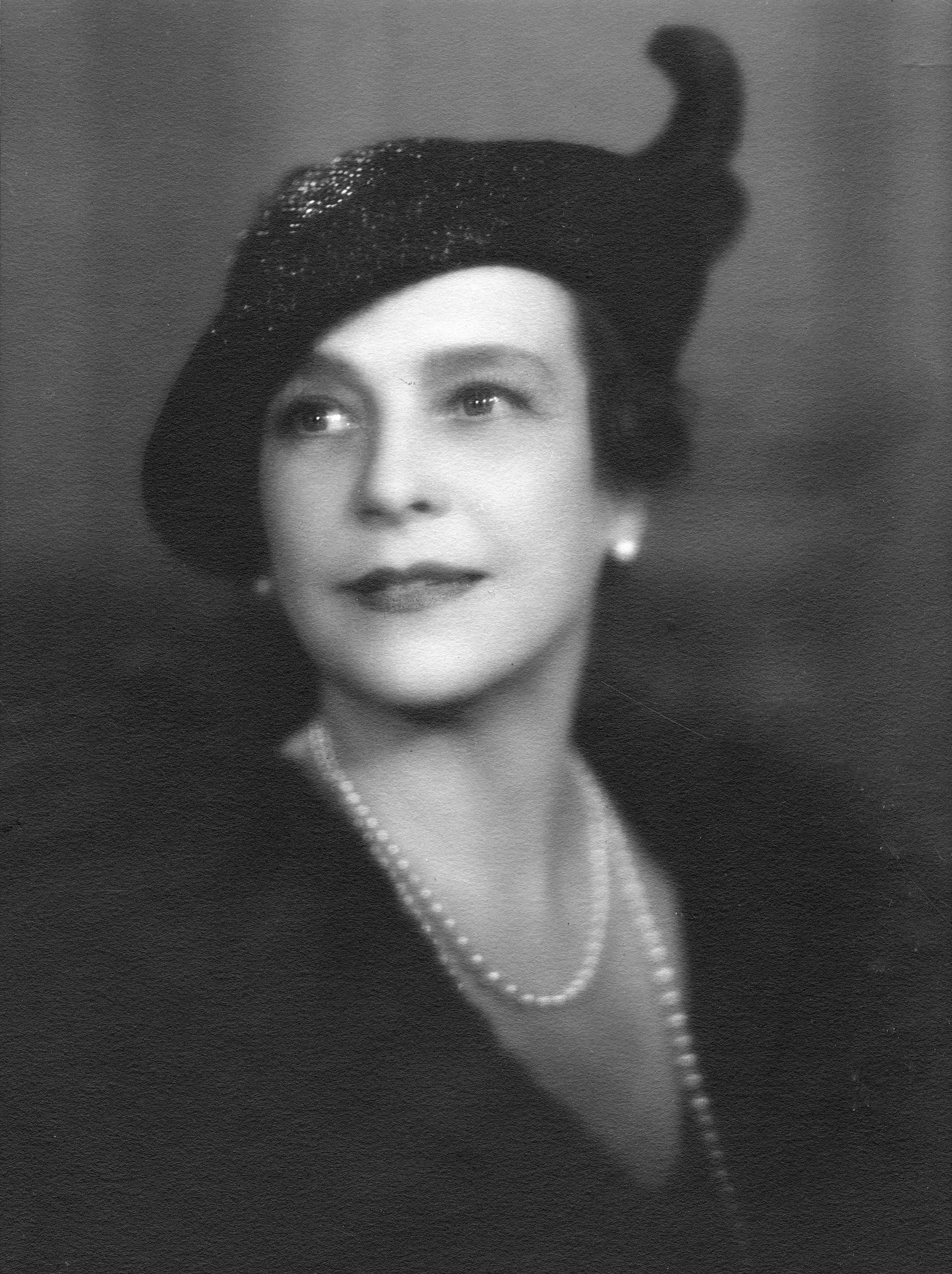 Julie Penrose in hat and pearls